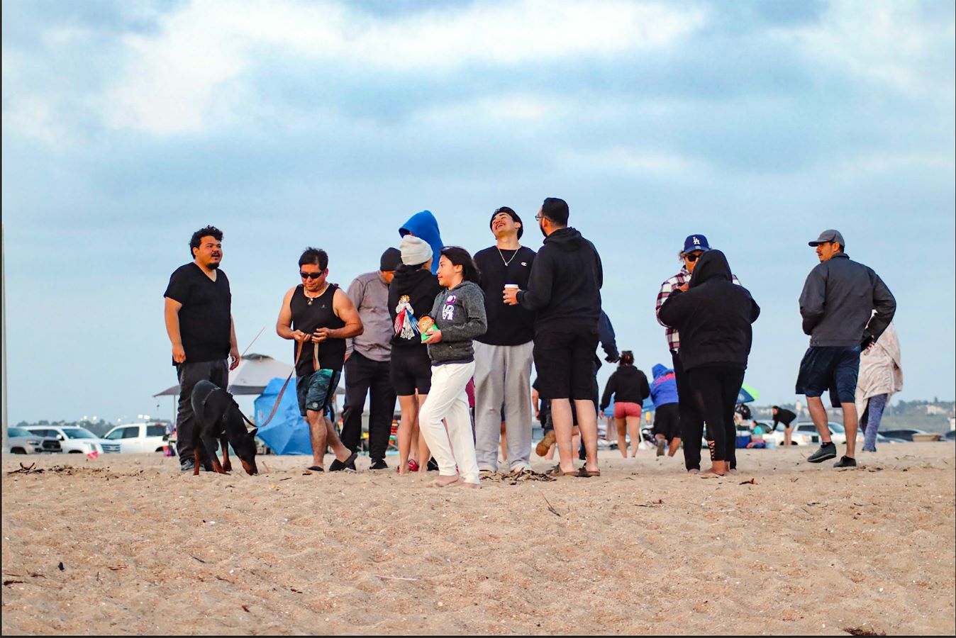 Missionary Souls Beach Gathering Members of the Missionary Souls young adult ministry gather on the beach. A bright blue sky behind them.