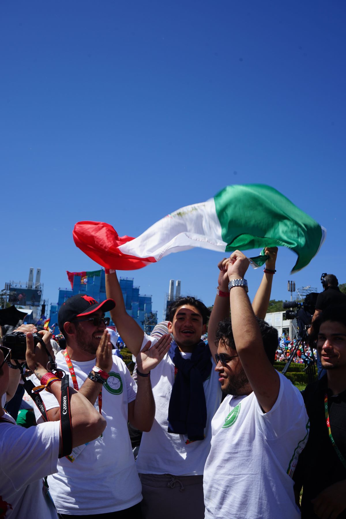 World Youth Day participants wave an Italian flag over their heads